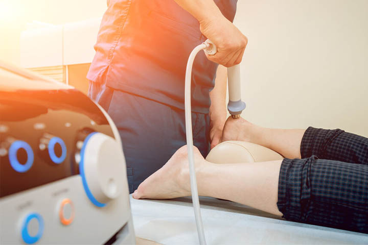 ESWT Treatment being performed on heel of a woman